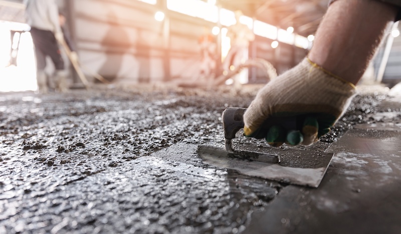 Construction site of buildings pouring cement Top view new screed concrete with leveling mortar for floors Construction site of buildings pouring cement. Top view new screed concrete with leveling mortar for floors.